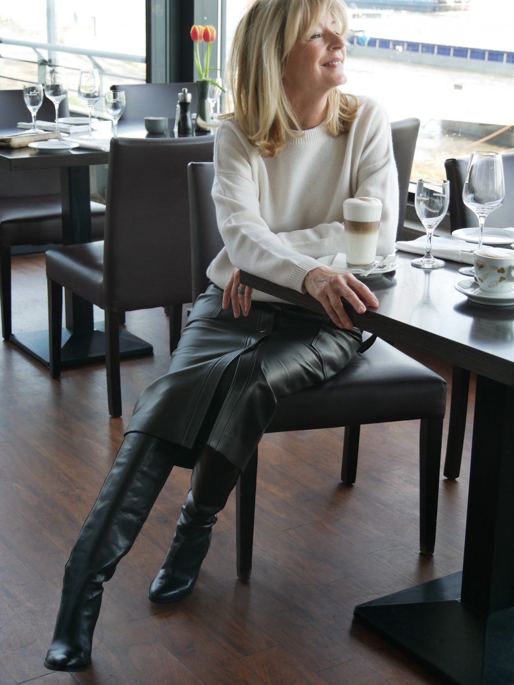 CharismaLook_Ausstrahlung_Mode_Restaurant_Ambiente_Lederrock_Lederstiefel_Weiß_Pullover_Kaffee_Blond